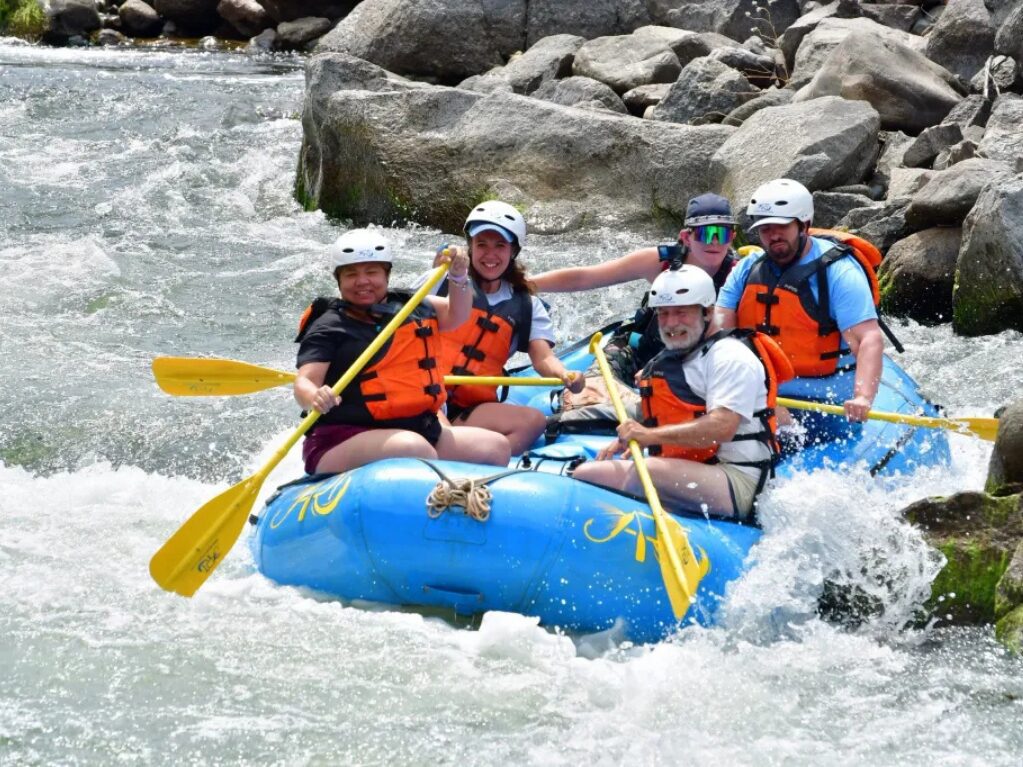 Group whitewater rafting on a river
