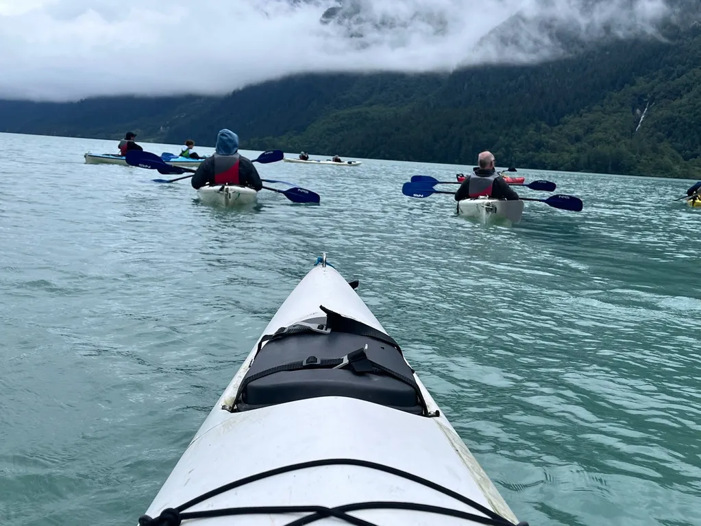 Kayakers paddling on a serene lake